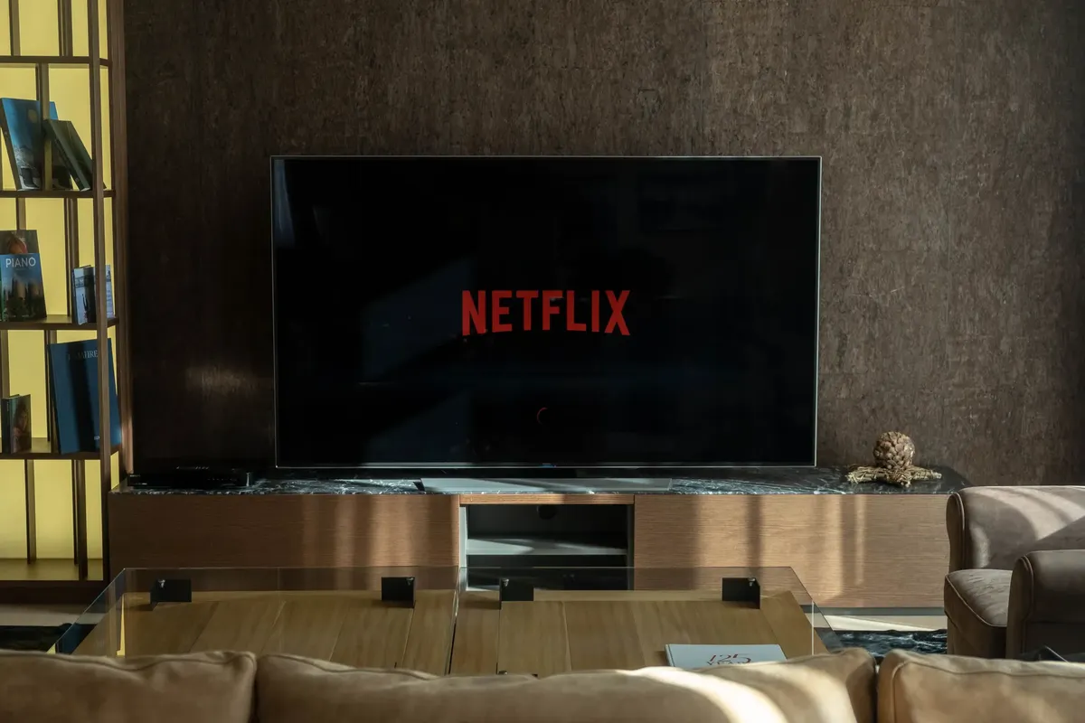 Cozy living room featuring a large TV displaying Netflix, perfect for entertainment.