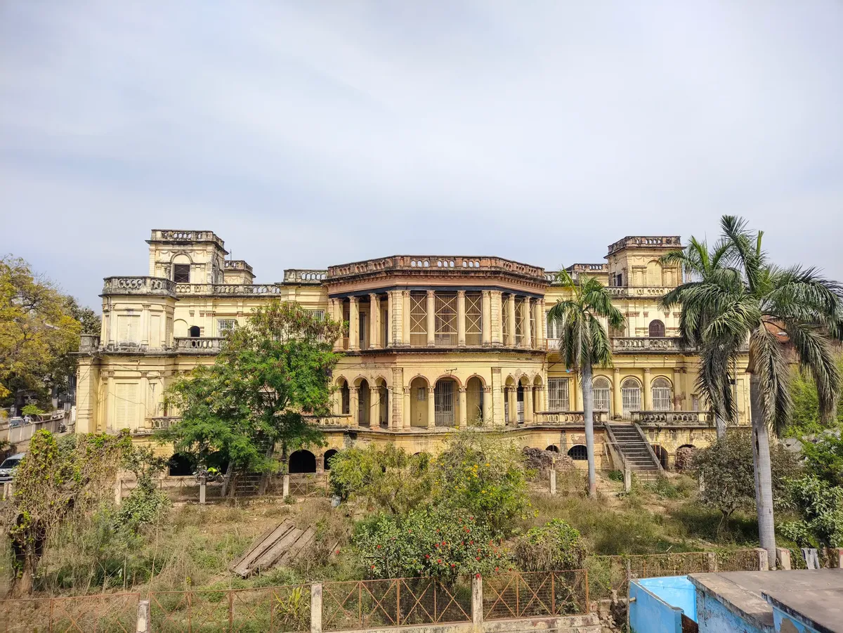 Beautiful colonial-era architecture in Lucknow, surrounded by lush greenery and palm trees.