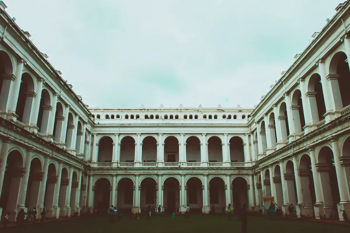 Exterior view of the historic Indian Museum in Kolkata showcasing classic colonial architecture with arches and columns.