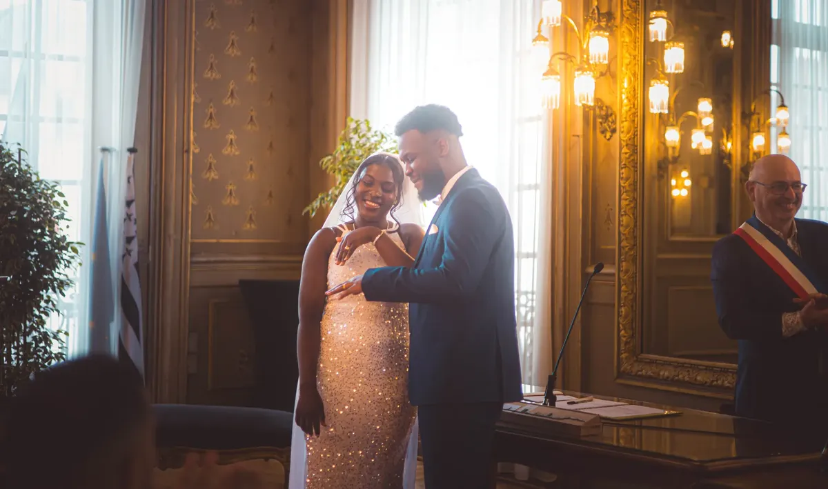 Elegant wedding ceremony with couple exchanging rings indoors.