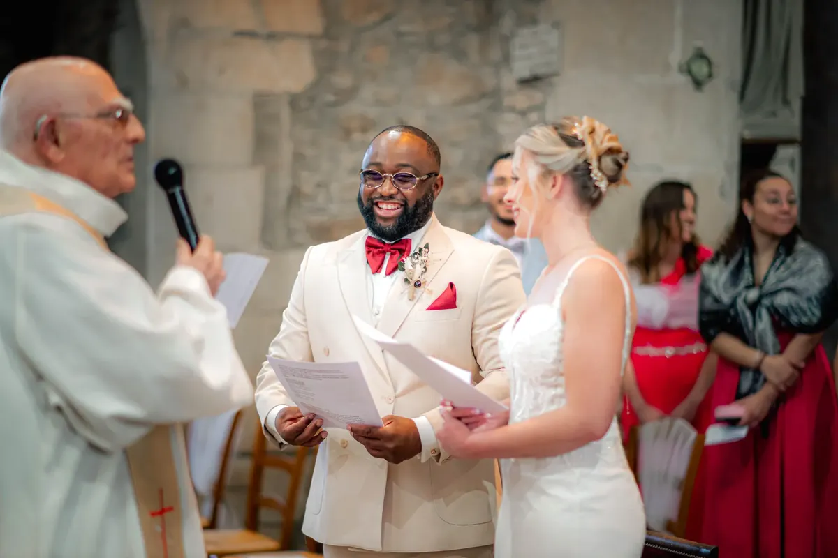 A joyful wedding ceremony inside a historic stone church, capturing the bride, groom, and officiant.