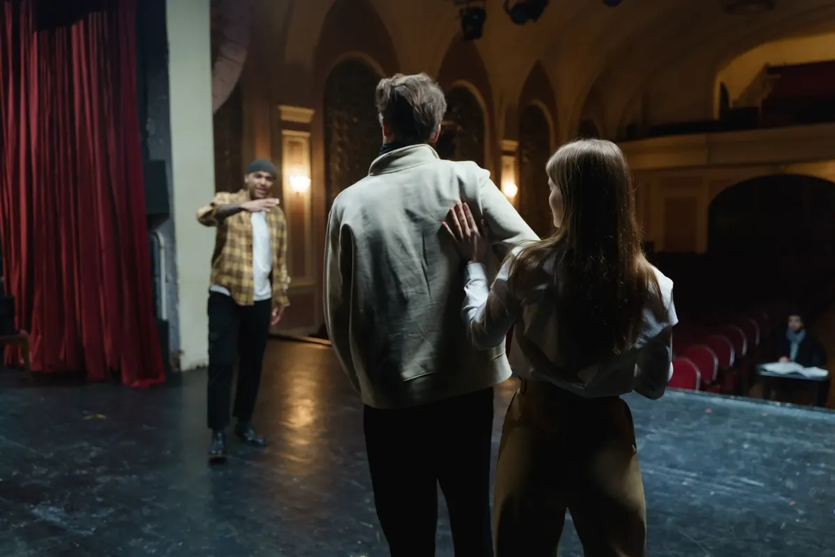 Actors in rehearsal on stage, capturing the art and emotion of theater.