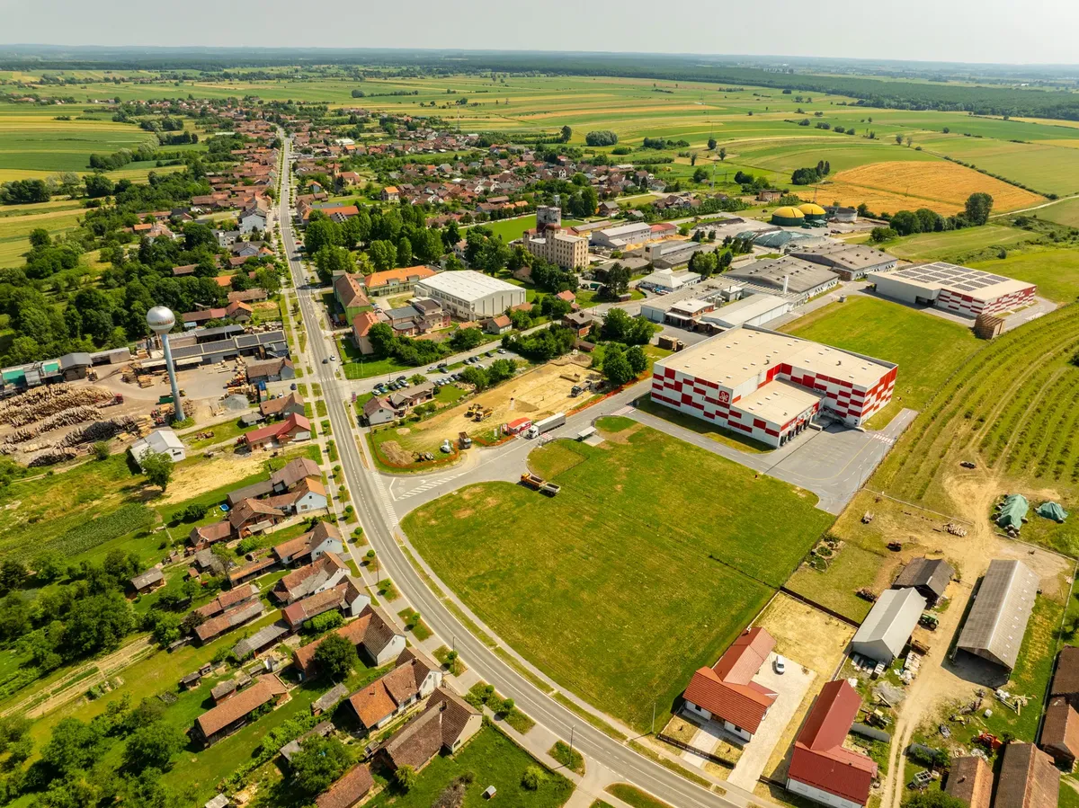 Aerial shot of Hercegovac, Croatia showcasing the town and industrial area.