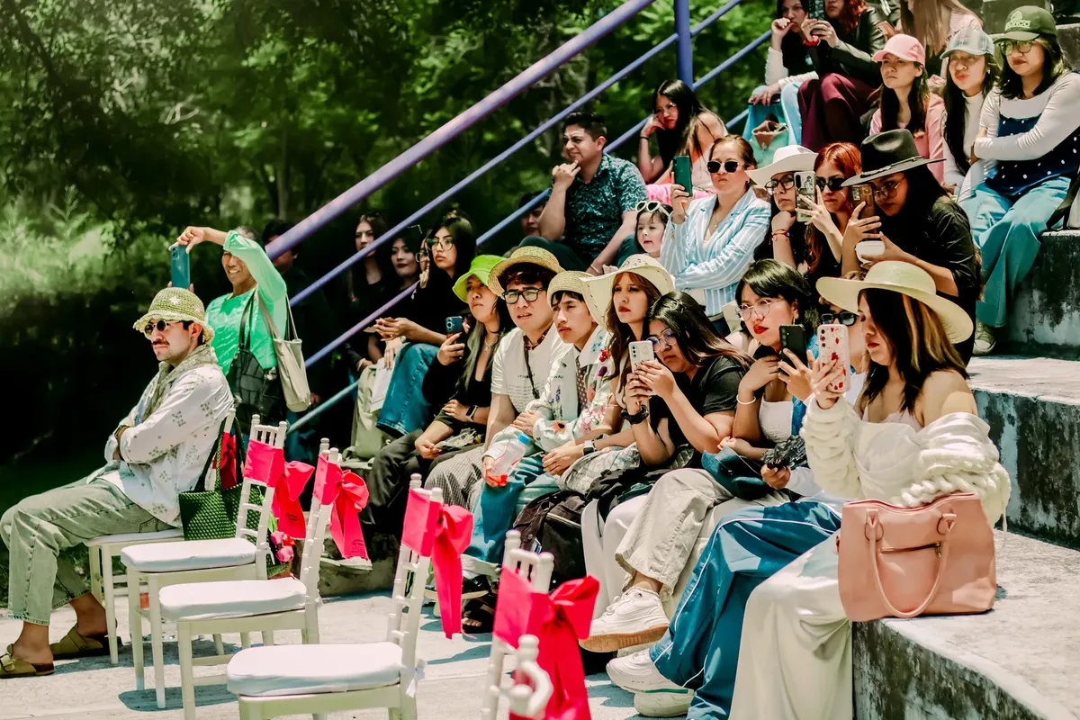 Stylish group of people attending an outdoor event in Tlaxcala, México, showcasing vibrant fashion trends.