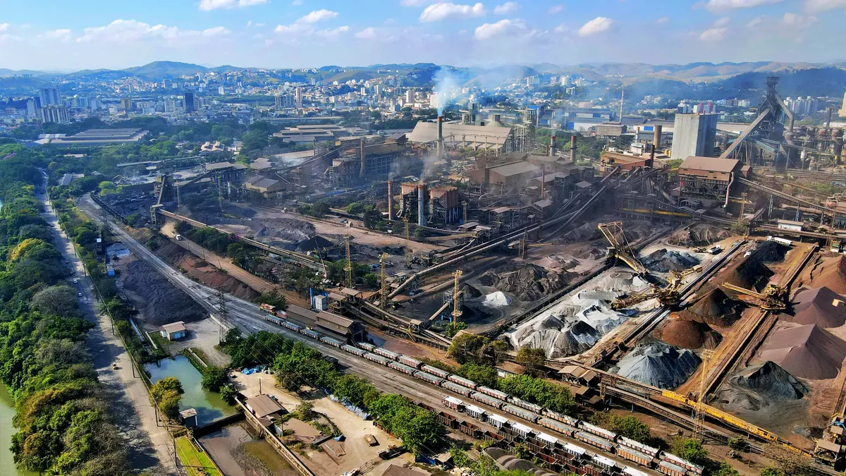 Aerial shot of a bustling industrial area in Rio de Janeiro, Brazil showing factories and cityscape.