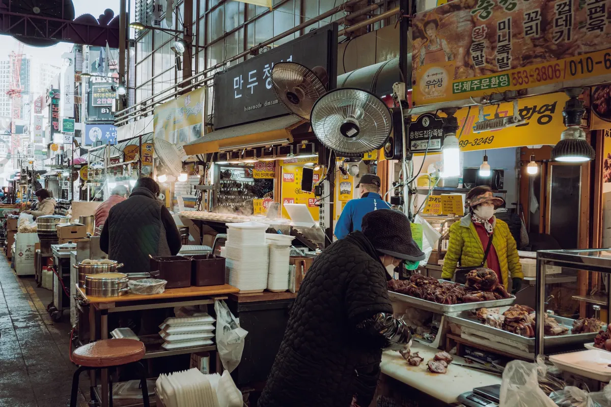 Vibrant street market in Guri-si with vendors and local shoppers showcasing Korean culture.