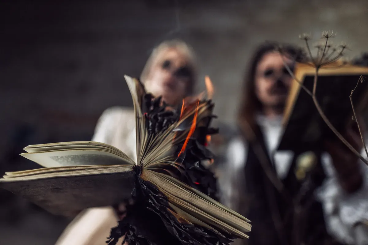 Close-up of an open book being burned, creating a dramatic and intense atmosphere.